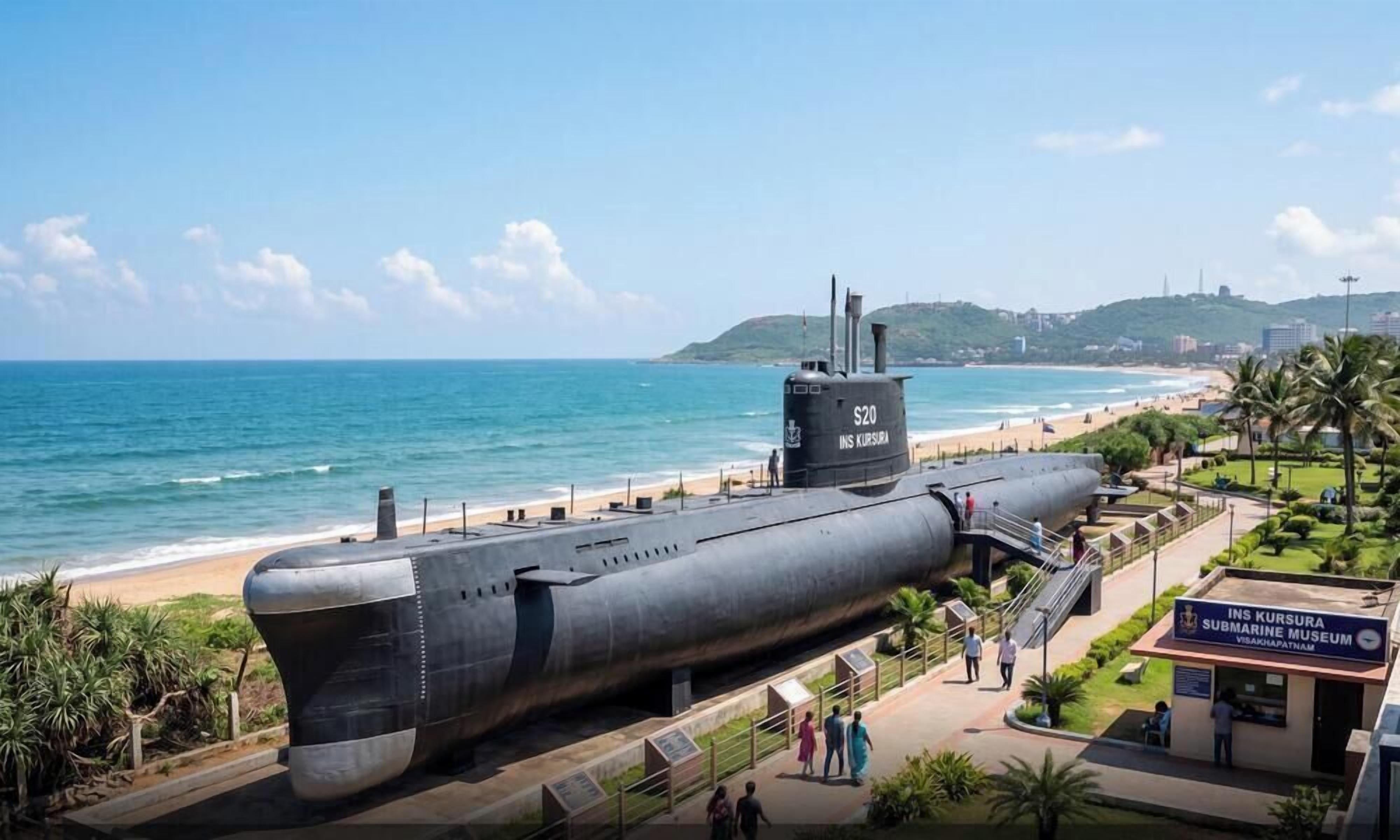 A submarine on display near a beach with a museum sign.