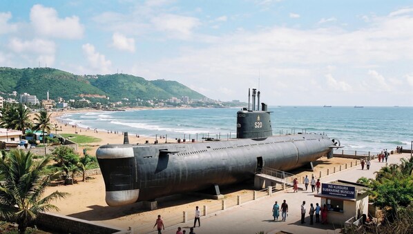 A submarine on display at a museum with a beach and ocean in the background. - Super Collection O Beach Road Near GITAM (Visakhapatnam)