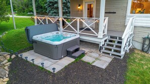 A hot tub with a wooden deck and steps leading to a house. - Greystone Lavender Farm-Hot Tub|Pool Table|KoiPond (Meaford)