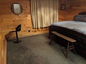 A wooden room with a bed, a chair, a bench, a clock, and a curtain. - Gated property - 3 bedroom 2 bath plenty of room for your toys (Kingston)