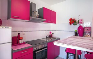 A kitchen with pink cabinets, a stove, an oven, and a sink. - Amazing apartment in Trogir with swimming pool (Trogir)