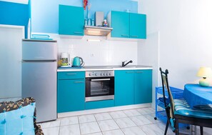 A compact kitchen with a refrigerator, stove, oven, and a sink. - Lovely apartment in Seget Vranjica with WiFi (Seget Vranjica)