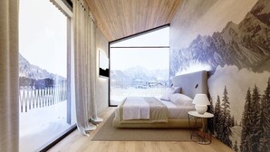 Quarto com uma grande janela, uma cama, uma mesinha de cabeceira e um mural na parede com paisagem montanhosa.