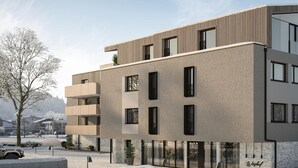 En flervåningsbyggnad med modern design, utrustad med balkonger och stora fönster.