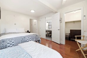 A bedroom with two beds, a wooden floor, a desk with a chair, and a wardrobe. - Waterfront - Sauna -Steps To Beach! (Saco)