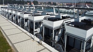 A marina with multiple boats docked, a pedestrian walkway, and a building with a staircase. - Dream houseboat with sea view and hot tub (Novigrad)