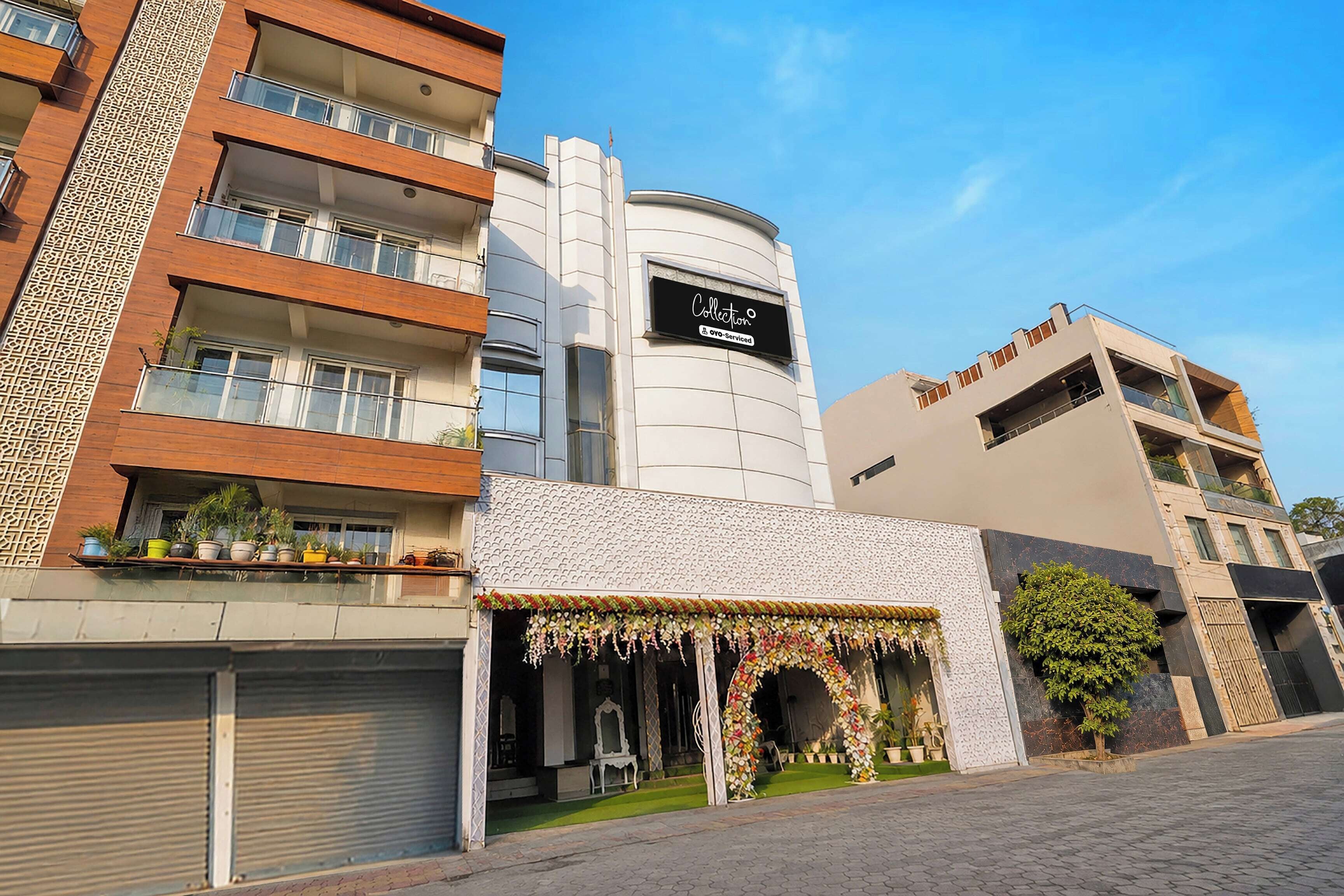 A multi-story building with a modern facade, a visible storefront with a sign, and a gated entrance.