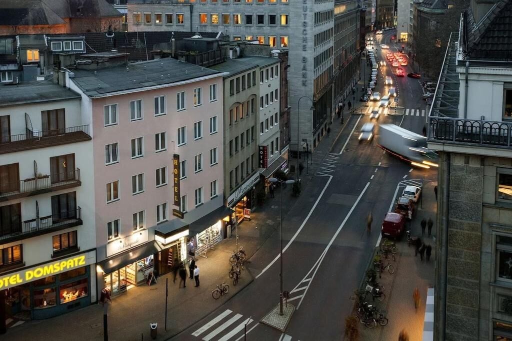 A multi-story hotel with a ground floor restaurant and a visible crosswalk.