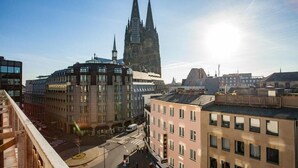 A hotel with a view of a cathedral in the background.