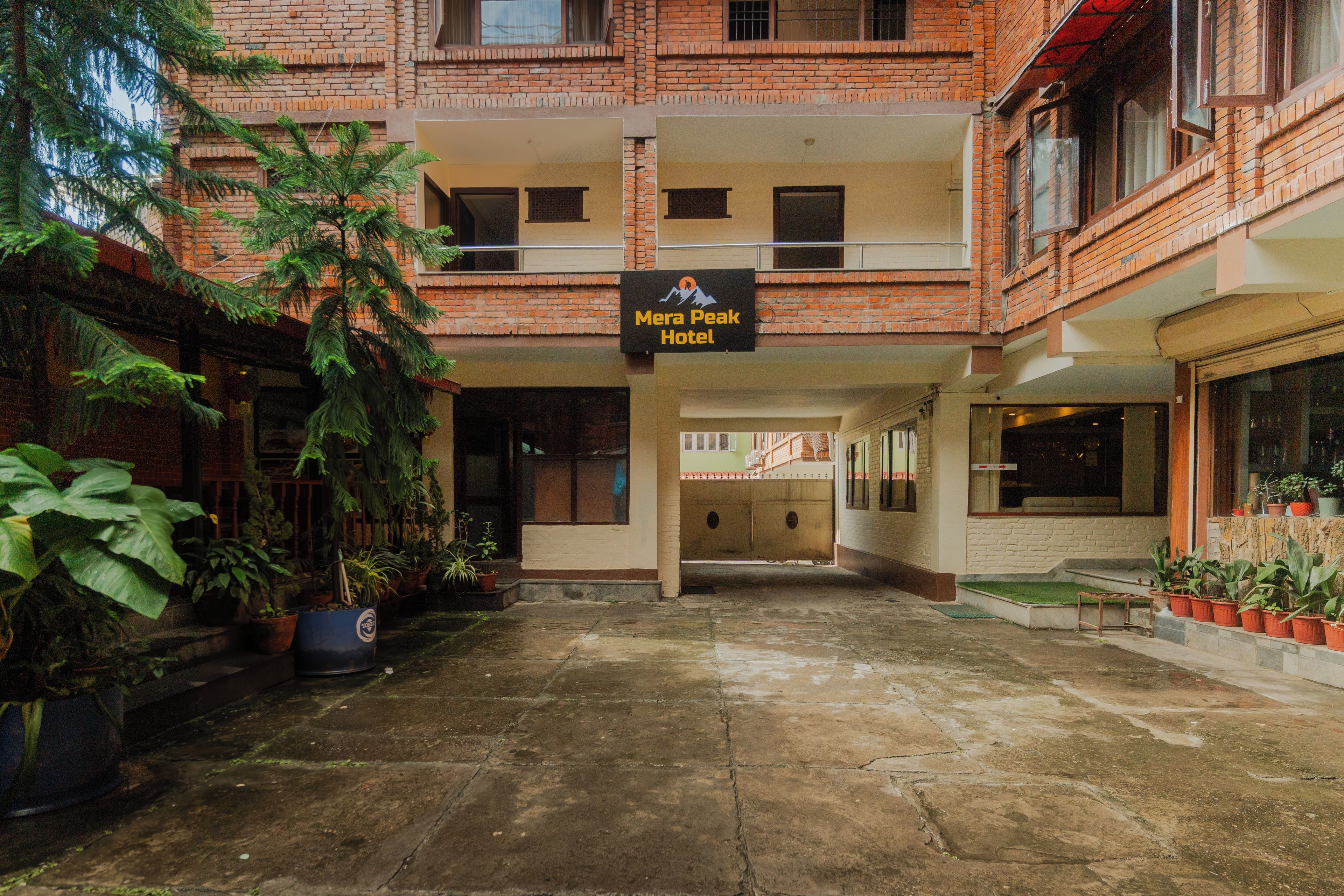A hotel entrance with a sign for 'Mera Peak Hotel'.