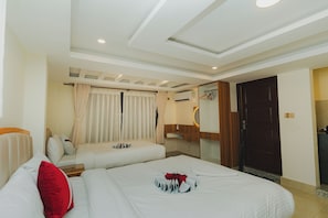 A hotel room with two beds, a wooden wardrobe, a mirror, and an air conditioning unit. - Mera Peak Hotel (Kathmandu)