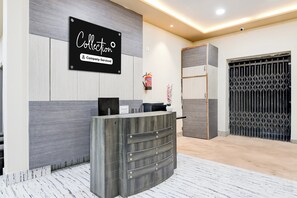 A reception desk with a sign that reads 'Collection Company-Serviced.'