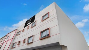 Un edificio de varios pisos con un cartel que indica que es un establecimiento de la empresa.