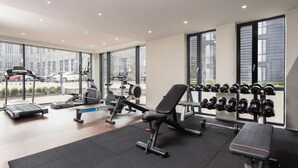 A gym with treadmills, elliptical machines, a bench, and a rack of dumbbells. - Student Only Causeway View (Aberdeen)