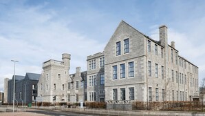 A large stone building with multiple windows and a prominent tower. - Student Only Causeway View (Aberdeen)