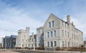 A large stone building with multiple windows and a prominent tower. - Student Only Causeway View (Aberdeen)
