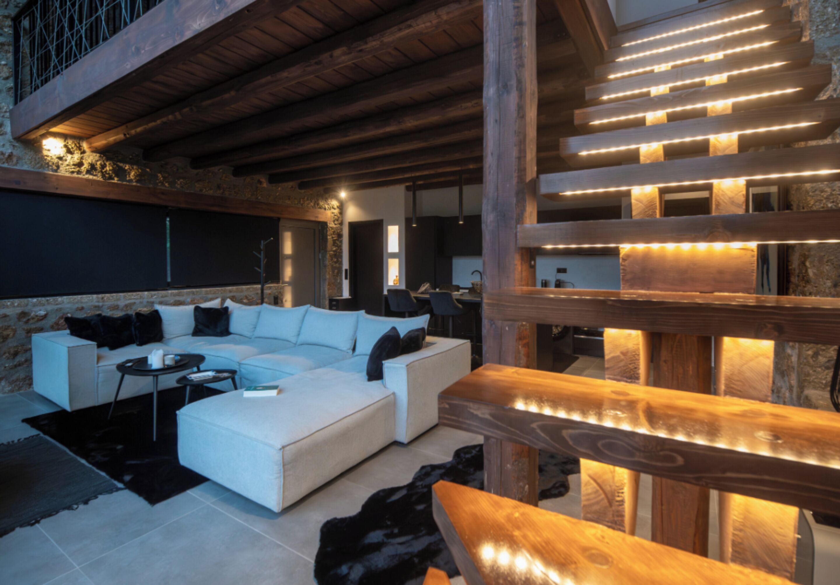 A modern living room with a sectional sofa, a coffee table, and a wooden bench.