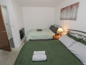 A hotel room with two beds, a TV, a lamp, and a painting on the wall. - 4 Pump House (Birmingham)
