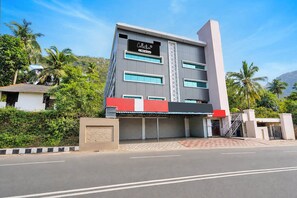 A multi-story building with a modern design, featuring a large signboard, multiple windows, and a gated entrance. - Super Collection O Tennati Park Vizag (Visakhapatnam)
