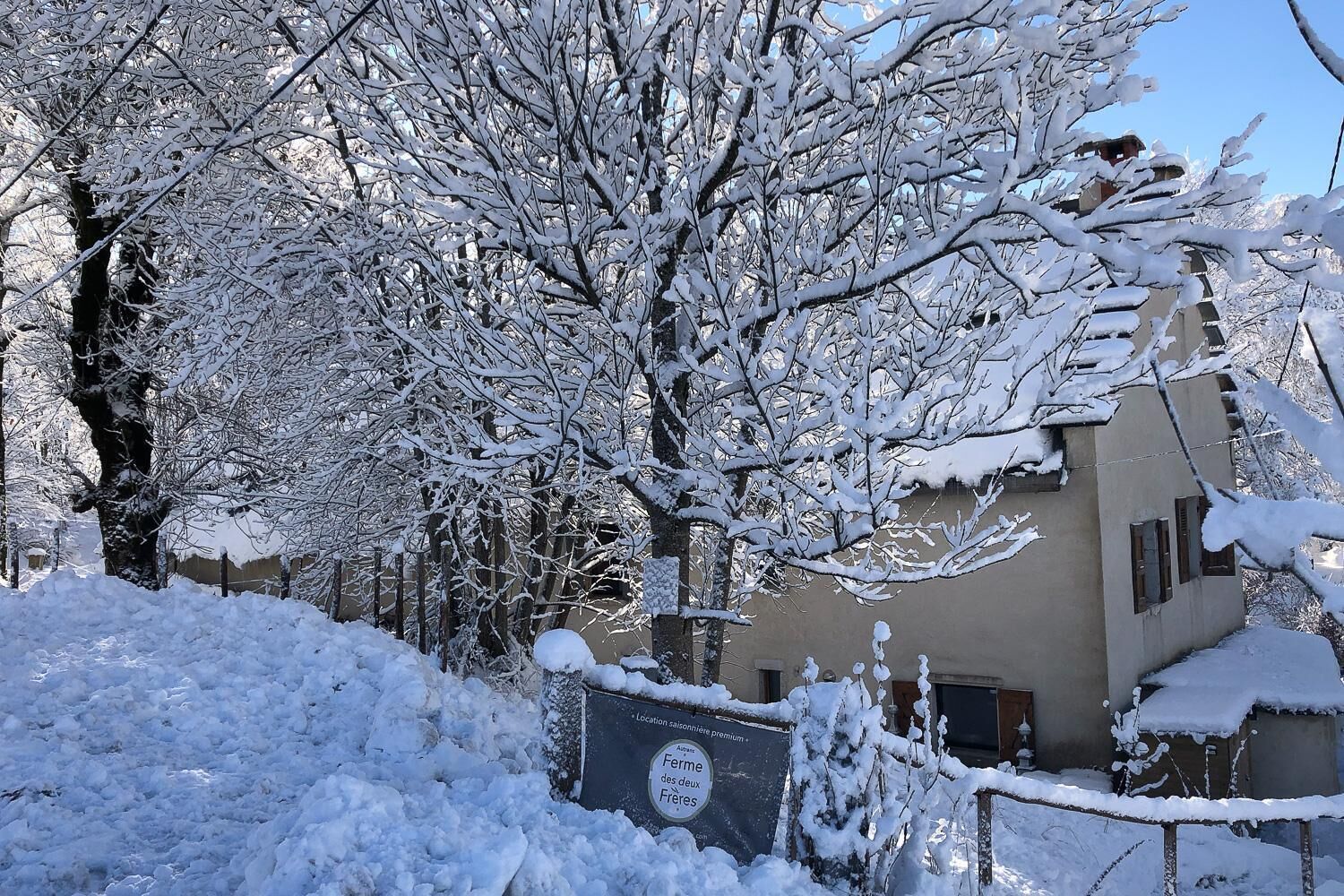 A snow-covered building with a sign indicating a premium location.