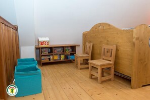 A room with a wooden bunk bed, a bookshelf with various items, and two chairs. - The Violets of Grand Veymont (GRESSE EN VERCORS)