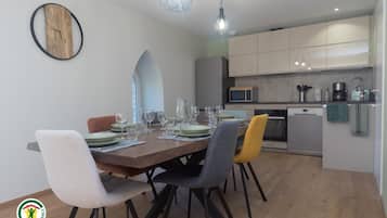 A modern kitchen with a microwave, coffee maker, and sink.