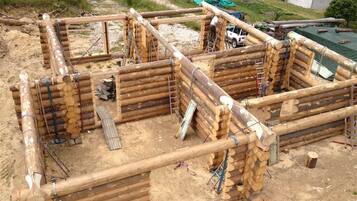 A construction site with wooden structures and a white vehicle.