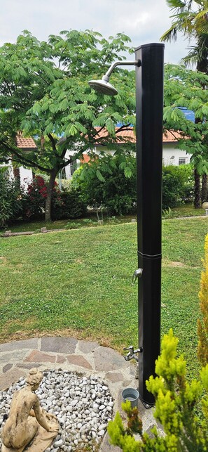 A garden with a water feature, a statue, and a well-maintained lawn. - The Hidden Gem, Lago Maggiore -- Very quiet house in a private complex with pool (Germignaga)
