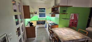 A compact kitchen with a gas stove, a sink, and a window above the countertop. - The Hidden Gem, Lago Maggiore -- Very quiet house in a private complex with pool (Germignaga)
