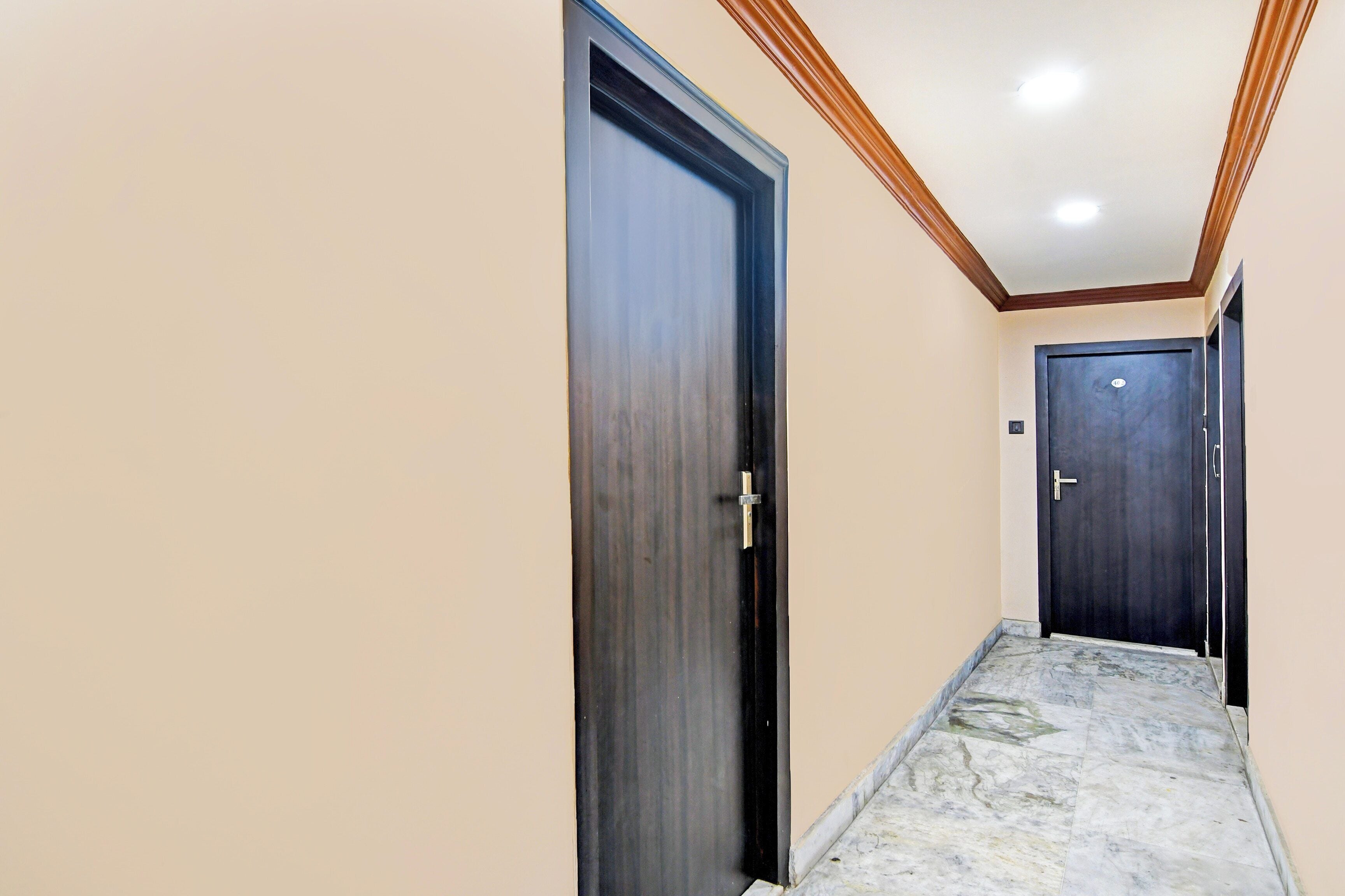 A hallway with two doors, one with a visible handle and the other with a visible lock.
