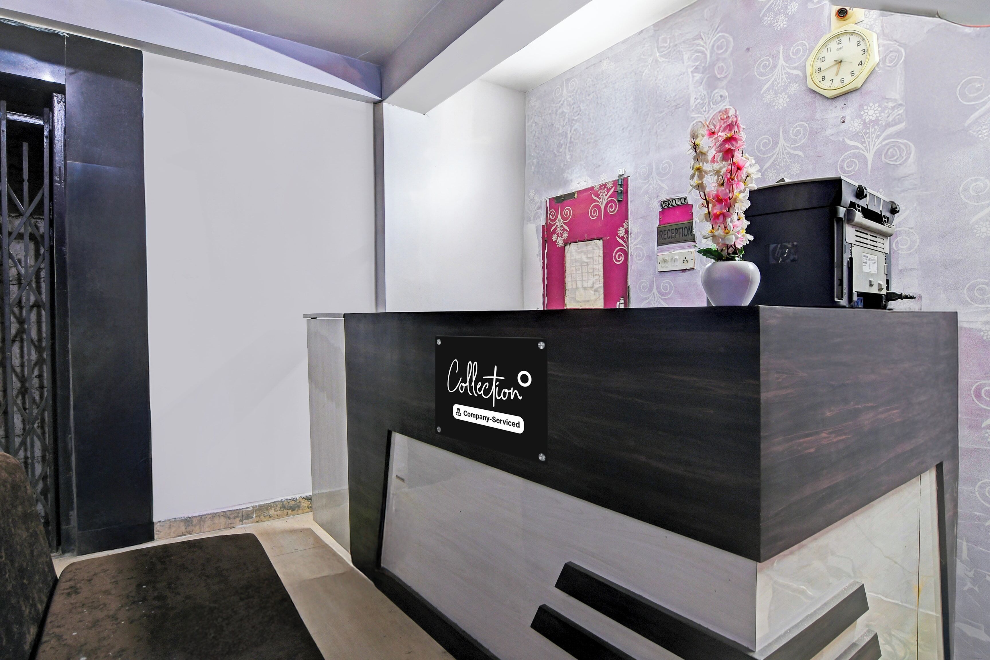 A reception desk with a sign indicating it's a company-serviced collection point.