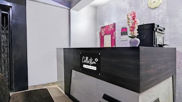 A reception desk with a sign indicating it's a company-serviced collection point.
