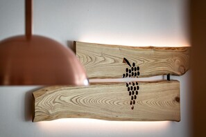 Two wooden wall art pieces with a pattern of holes. - Knöspele Brennerei & Genuss-Apartments Vinum. (Brixen)