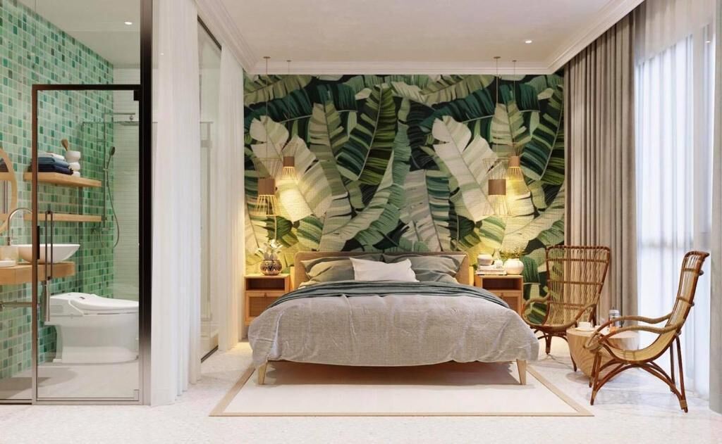 A modern bedroom with a large bed, a wall mural, bedside lamps, a wicker chair, and a glass shower enclosure.