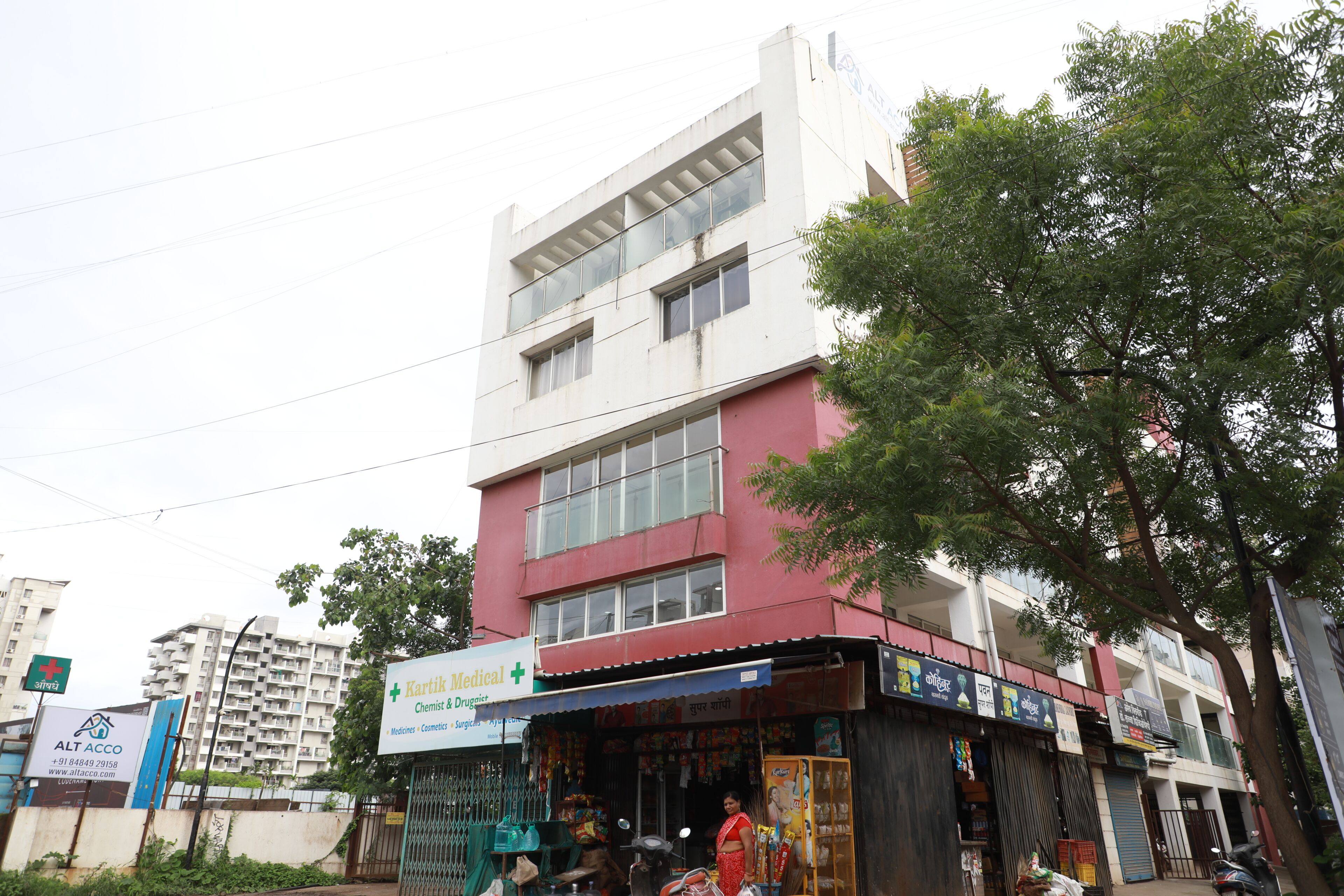 Un immeuble à plusieurs étages dont le rez-de-chaussée abrite une pharmacie.