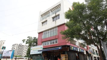 A multi-story building with a medical store on the ground floor.