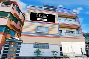 A multi-story building with a sign reading 'Collection Company-Serviced'.
