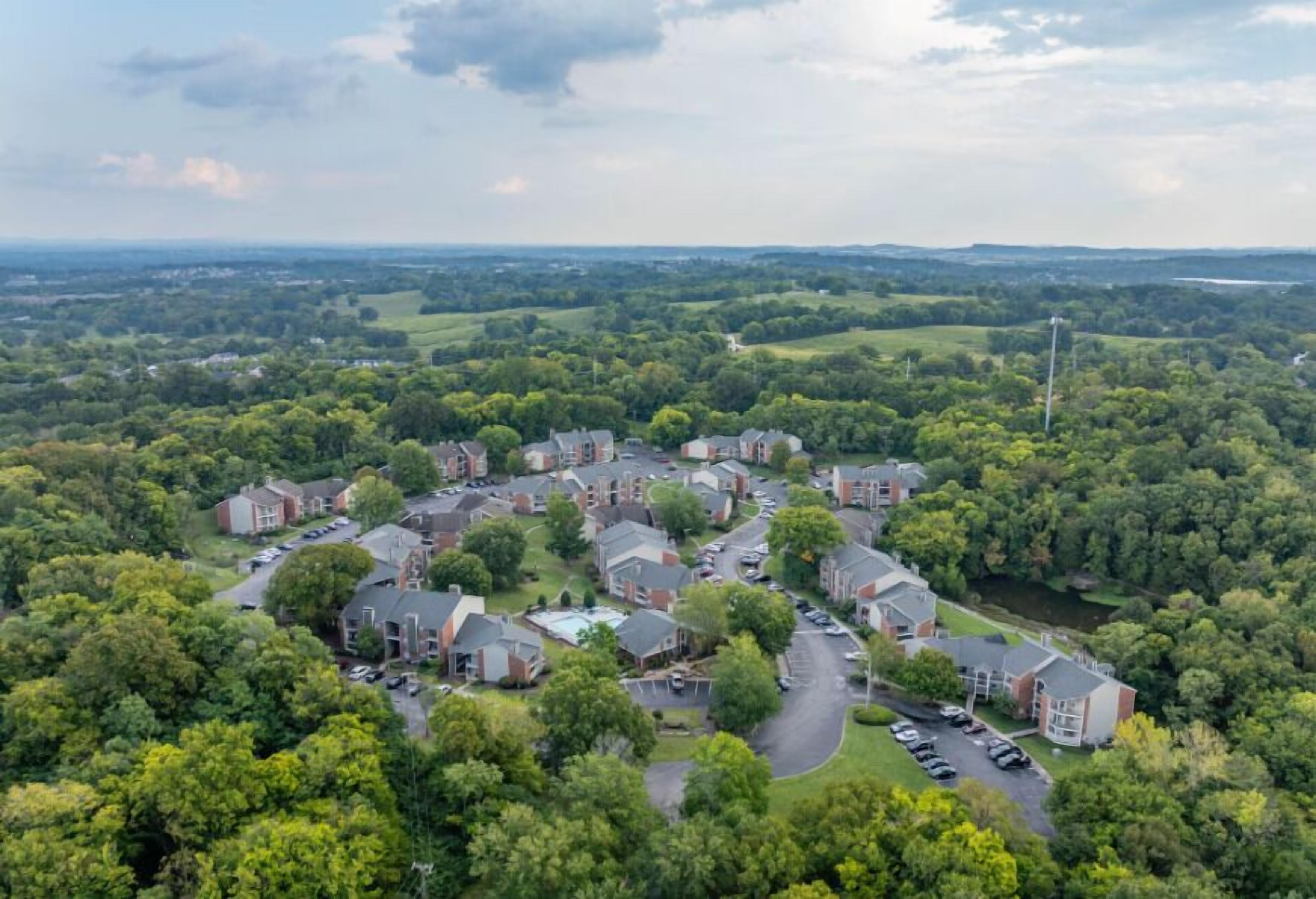 A residential area with houses, roads, and greenery.