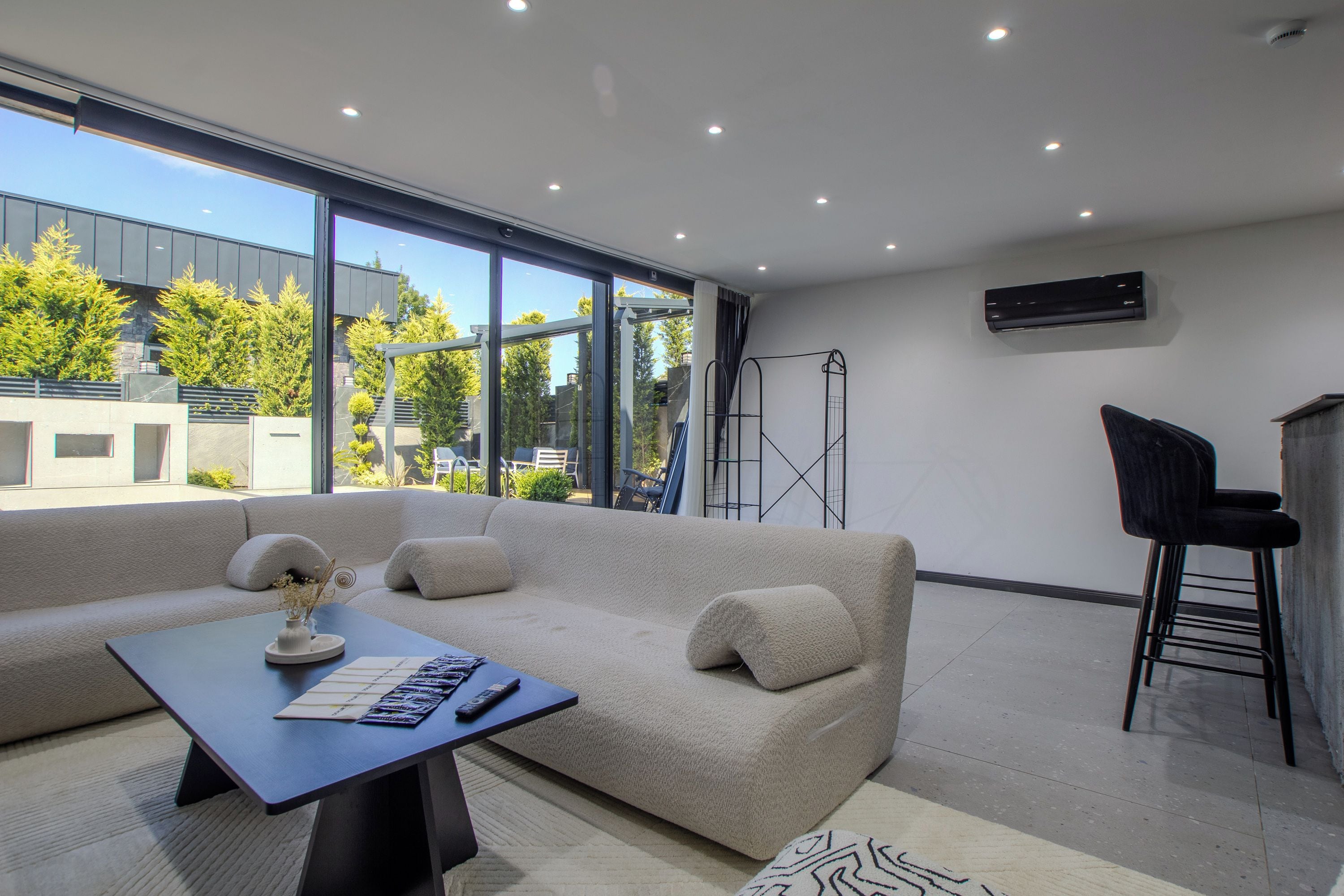 A modern living room with a sofa, a coffee table, and a TV.