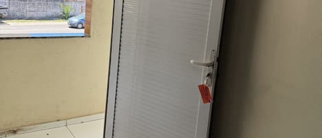 A closed door with a number sign, a metal handle, and a key lock.