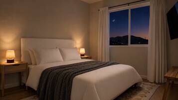 A hotel room with a bed, nightstands, a window with a view of the night sky, and a curtain.