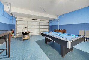 A pool table in a room with a blue wall and a white ceiling. - Luxury Solterra Resort Retreat | Near Disney (Davenport)