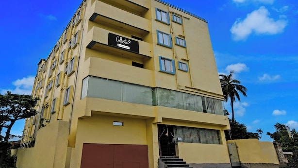 A multi-story building with a sign indicating it is a company-serviced collection.