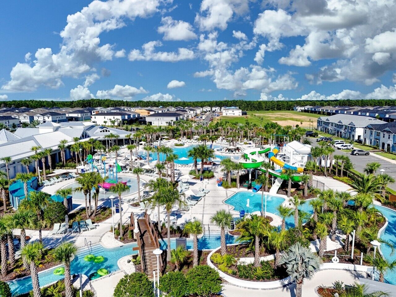 A resort with multiple swimming pools, a water park, and a variety of lounge areas.