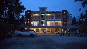 A multi-story building with a sign reading 'NAKSHATRA APARTMENTS.' - Pop Tavern Nakshatra Apartments  (Thiruvananthapuram)