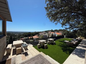 A patio area with outdoor furniture and a view of a residential area. - HAUS FARMS (Vila Nova de Anha Viana do Castelo)