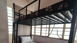 A bunk bed with a lower bunk and a mattress on the upper bunk. - Home away from home (Pune)