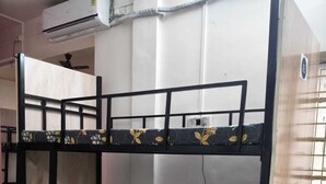 A bunk bed with a ladder, a white mattress, and a pillow. - Home away from home (Pune)