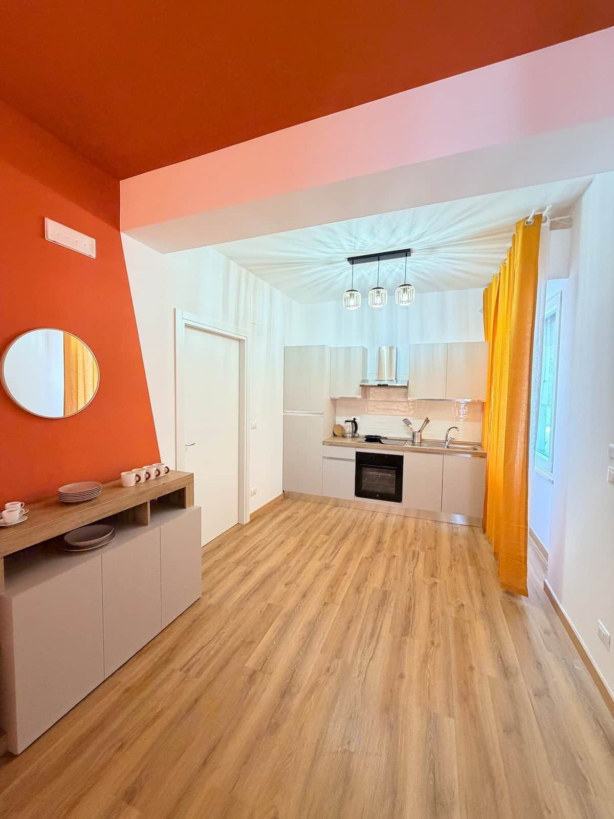 A modern kitchen with white cabinets, a wooden countertop, and a built-in oven.