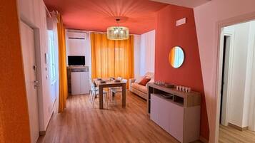 A modern interior with a dining area, kitchen, and a living space.